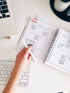 An employee writing notes in an organized schedule