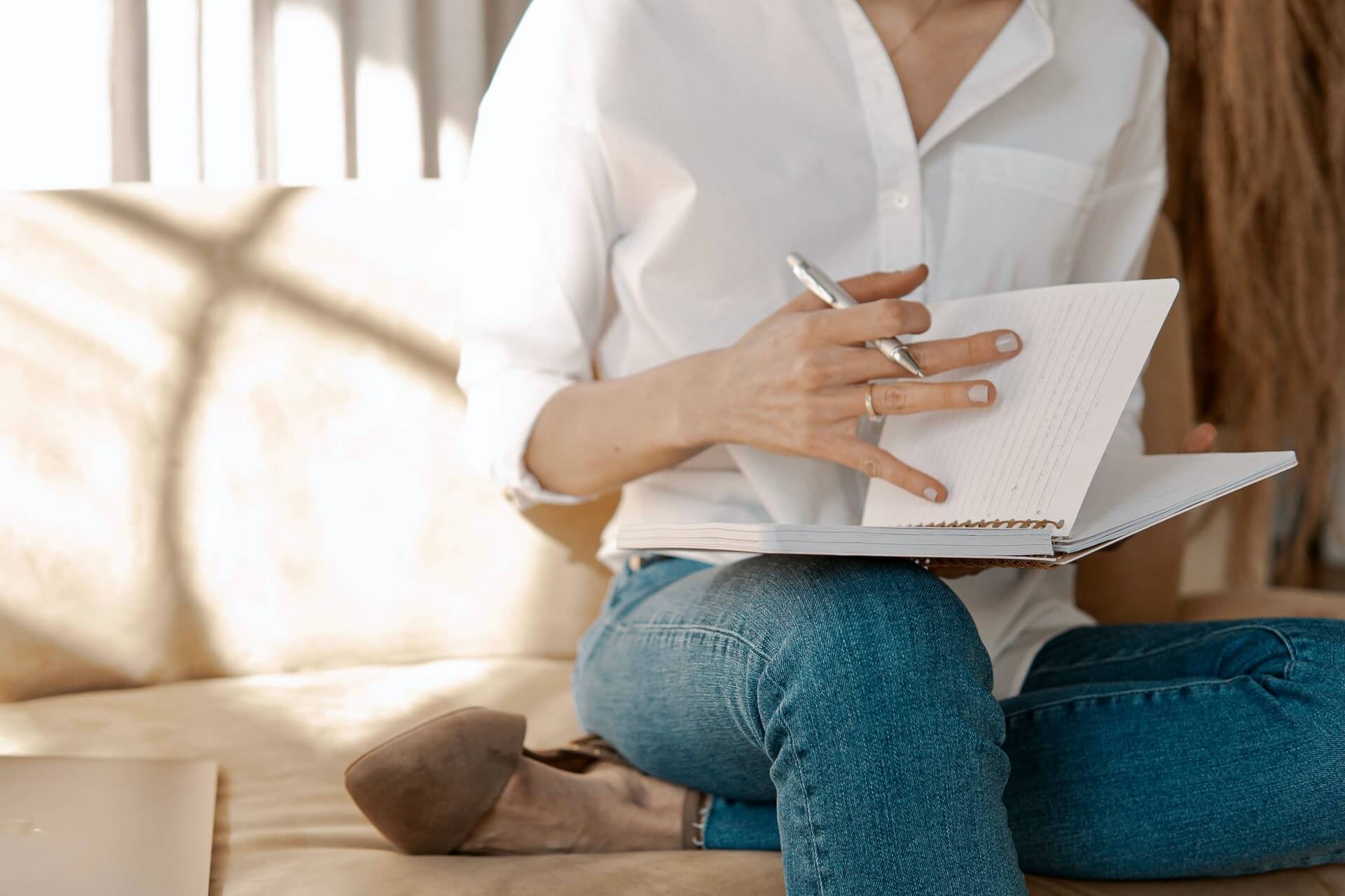 woman writing on a journal