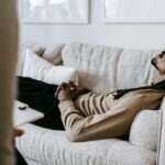 Man laying on a couch talking to a therapist