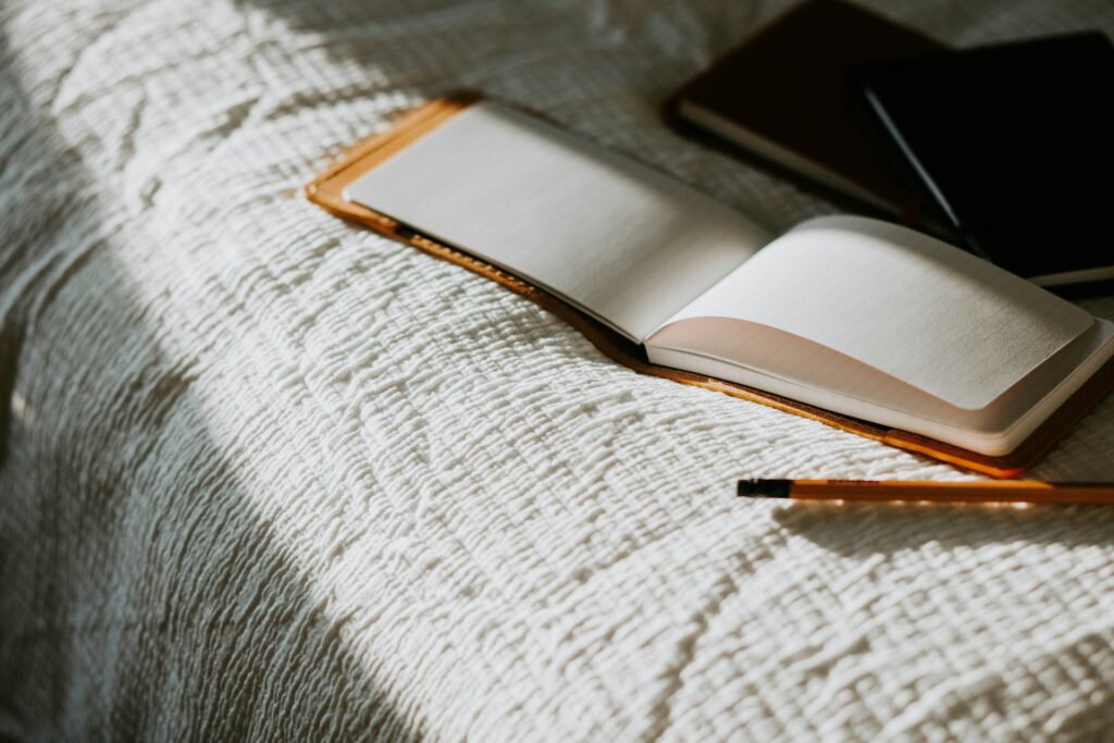 Journaling supplies set on a bed